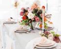 Reception table with rose floral arrangement