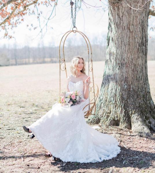 Bride posing on swing