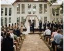 Outdoor wedding ceremony with contemporary arch